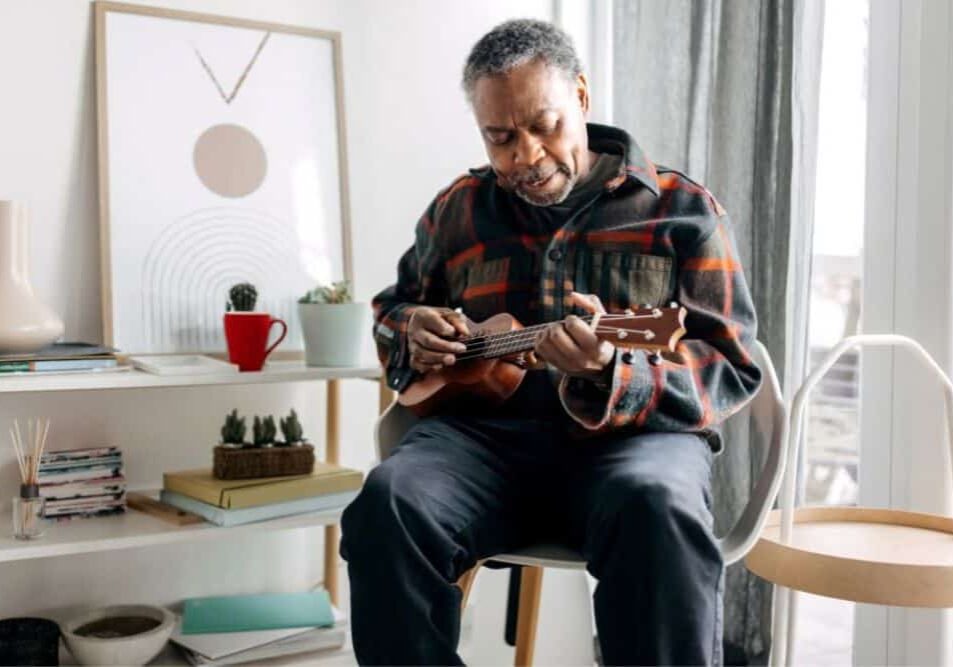 older gentleman playing ukulele