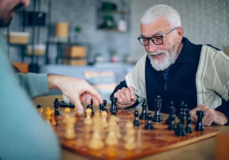 older gentleman playing chess in a cafe